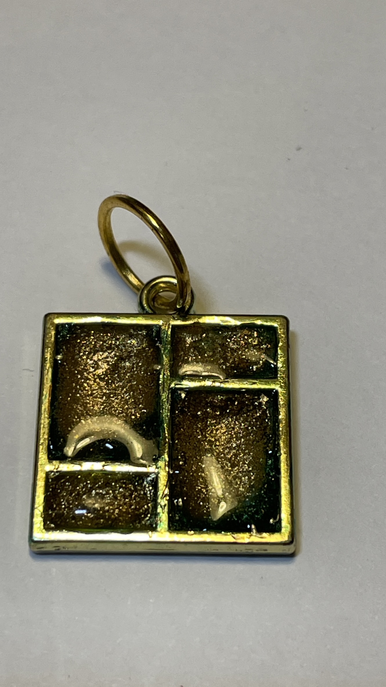 Hand made pendant crafted from green and gold ink and resin set in gold metal window bezel.