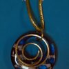 Blue resin pendant with clouds and a gold spiral