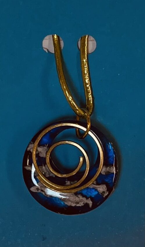 Blue resin pendant with clouds and a gold spiral