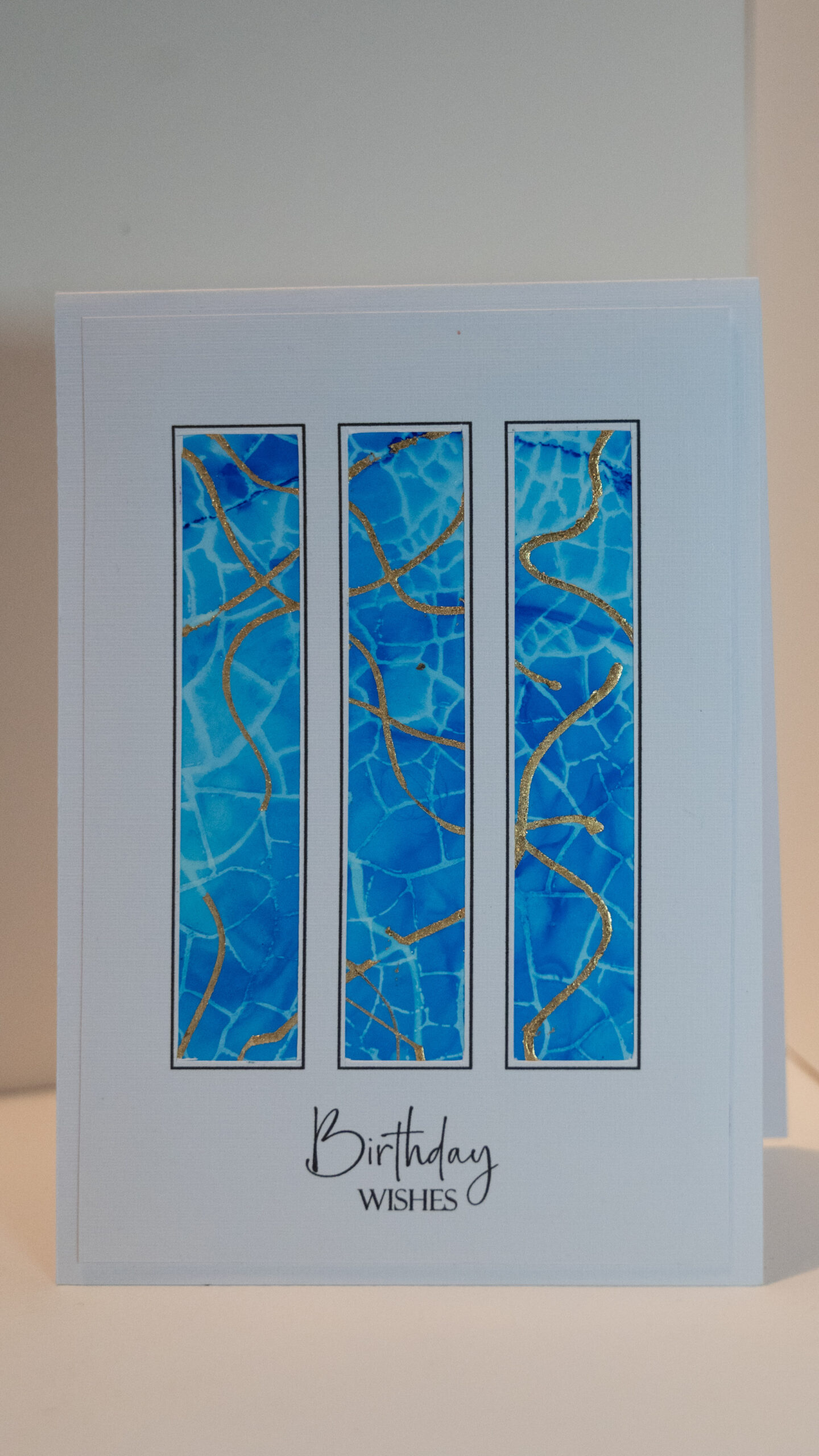 Hand made card with three vertical panels revealing gold and blue alcohol ink artwork. Blank inside, add a calligraphy message for the special person. 