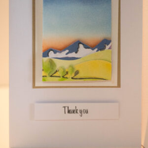 Hand crafted thank you card featuring a hand painted sunset backdrop with 3D mountains, hills and trees. 