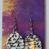 Hand crafted earrings with embossed black calligraphy, resin and silver ink surround.