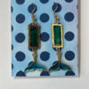 Hand crafted earrings made from colour-shift paint, alcohol ink and resin, set in gold bezels and featuring metallic blue and gold coloured whale tails.
