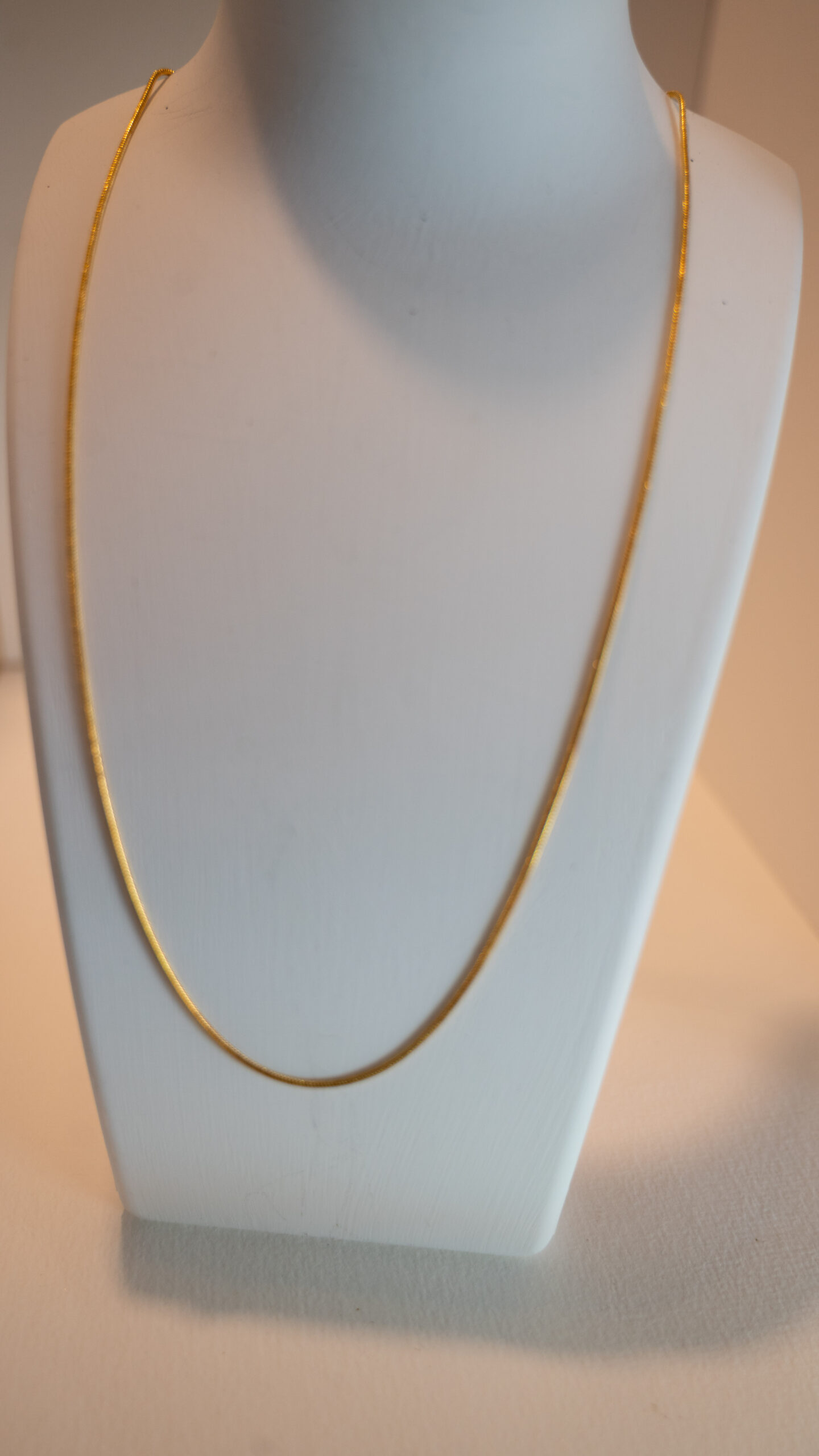 Gold coloured metal chain with lobster clasp.