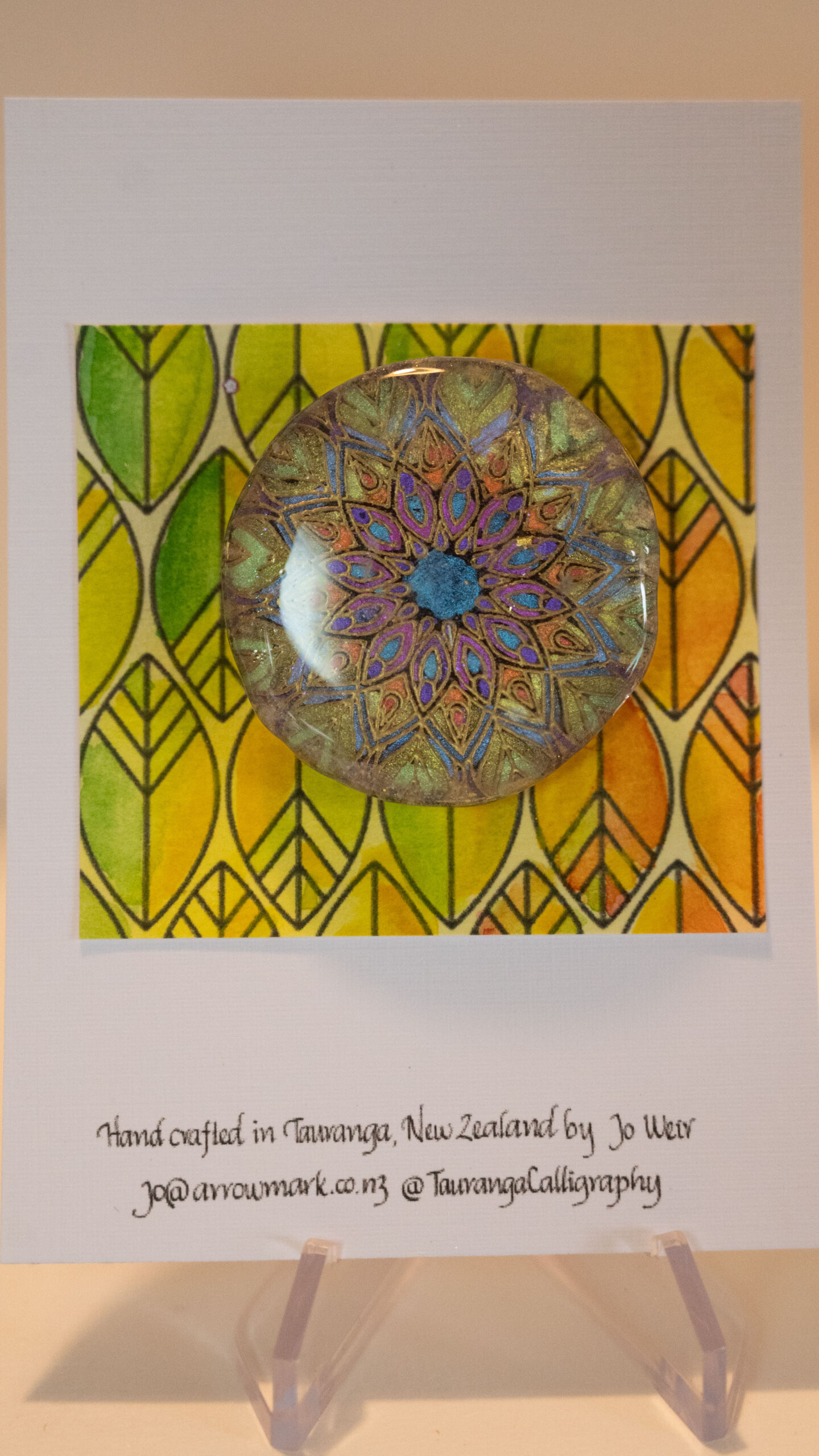 Tauranga jewellery: Brooch featuring gold embossed mandala hand coloured with metallic paints and protected with a resin layer