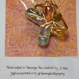 Hand crafted keyring in the letter X hand featuring alcohol inks, resin and gold ink. 