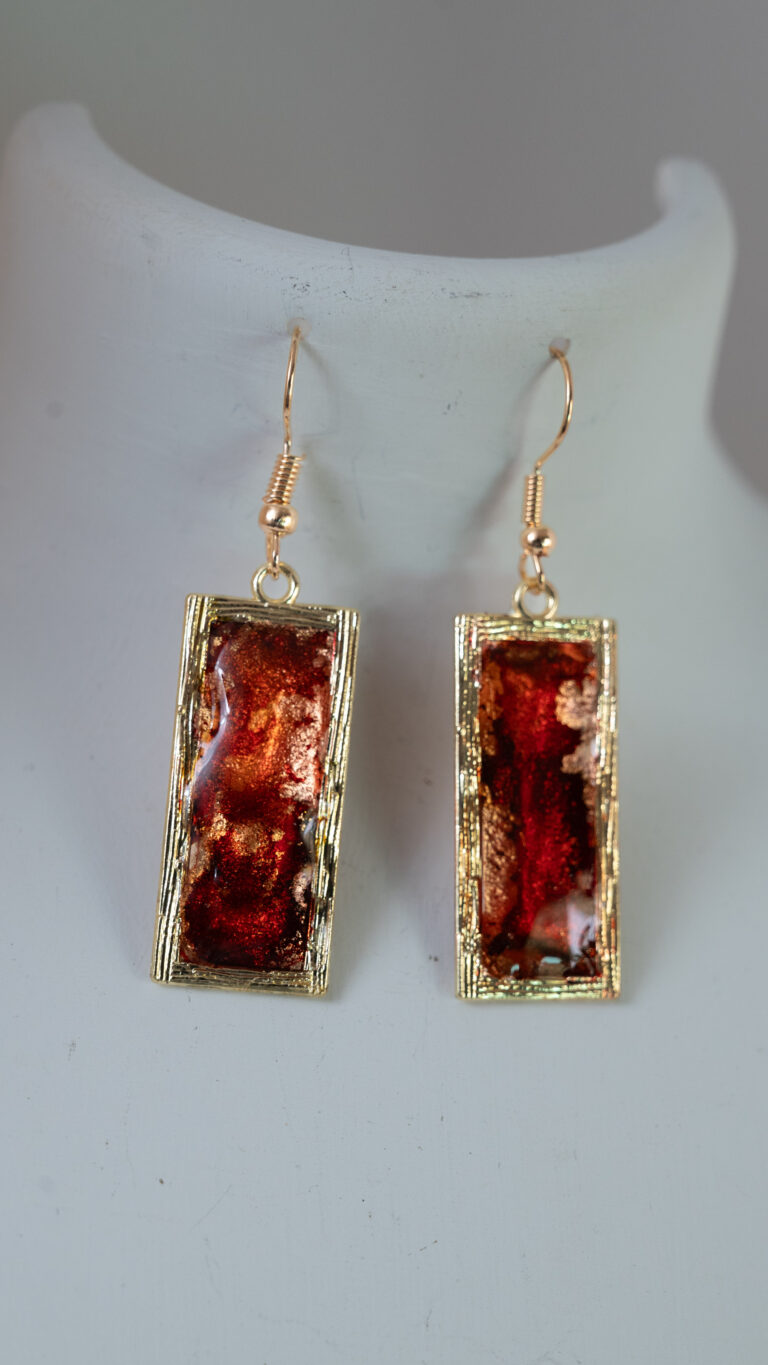 Tauranga jewellery: Earrings: Oblong gold bezels filled with red and gold ink and resin