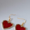 Tauranga Jewellery: Hand made earrings featuring red and gold inks and resin set in gold coloured heart shaped bezels