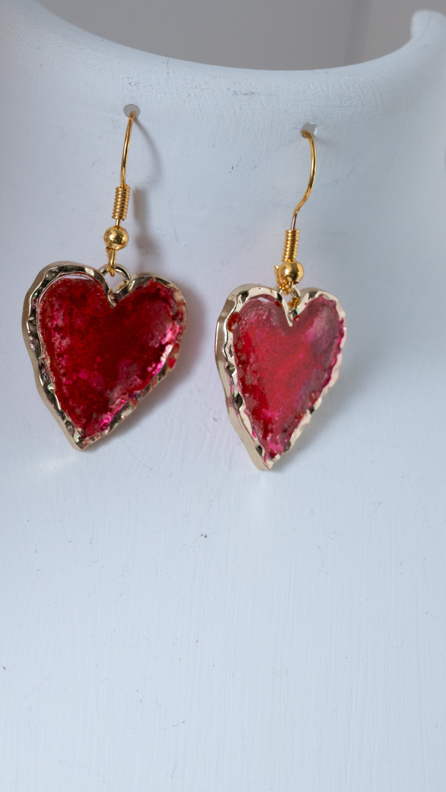 Tauranga Jewellery: Hand made earrings featuring red and gold inks and resin set in gold coloured heart shaped bezels