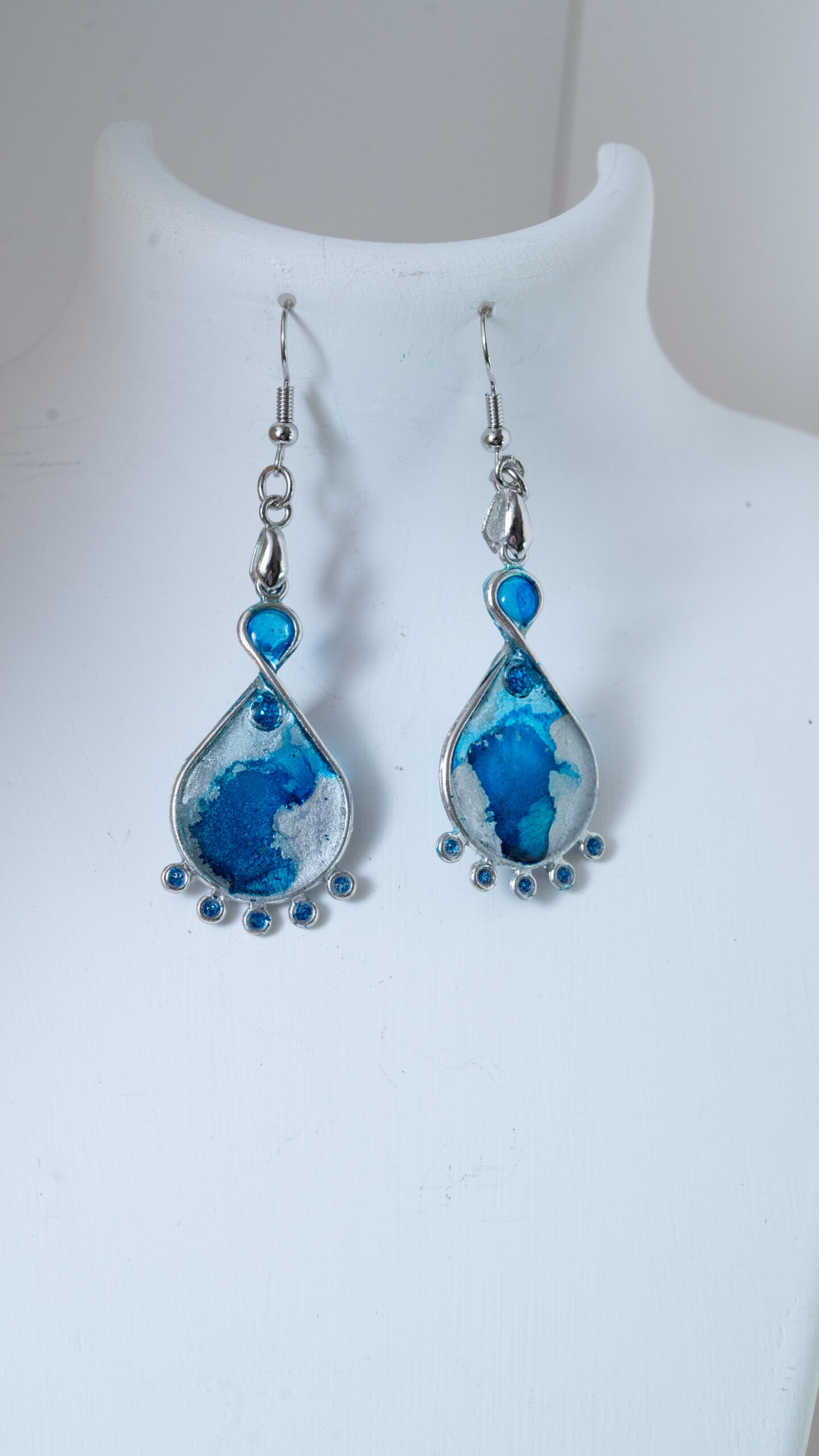Tauranga Jewellery: Hand made earrings featuring blue and silver inks and resin set in silver coloured bezels