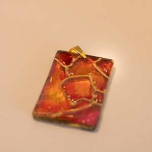 Pendant in pinks, reds and gold