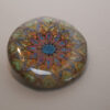 Tauranga Jewellery Brooch featuring gold embossed mandala hand coloured with metallic paints and protected with a resin layer