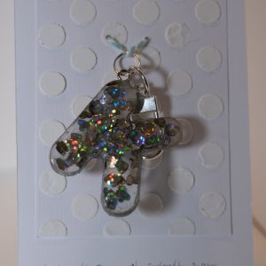 Key ring: Letter KOne of a kind, hand made in Tauranga, New Zealand. Ideal for a person whose name starts with K. Sparkly hologram hearts encased in resin.  Other letters can be made in this style, or this letter can be made in other styles. Please contact us for options.