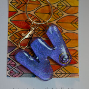 Gift: Key ring with letter ideal for a person whose name starts with W. Irridescent purpe paint encased in resin with a diamante on each side. One of a kind, hand made in Tauranga, New Zealand. 