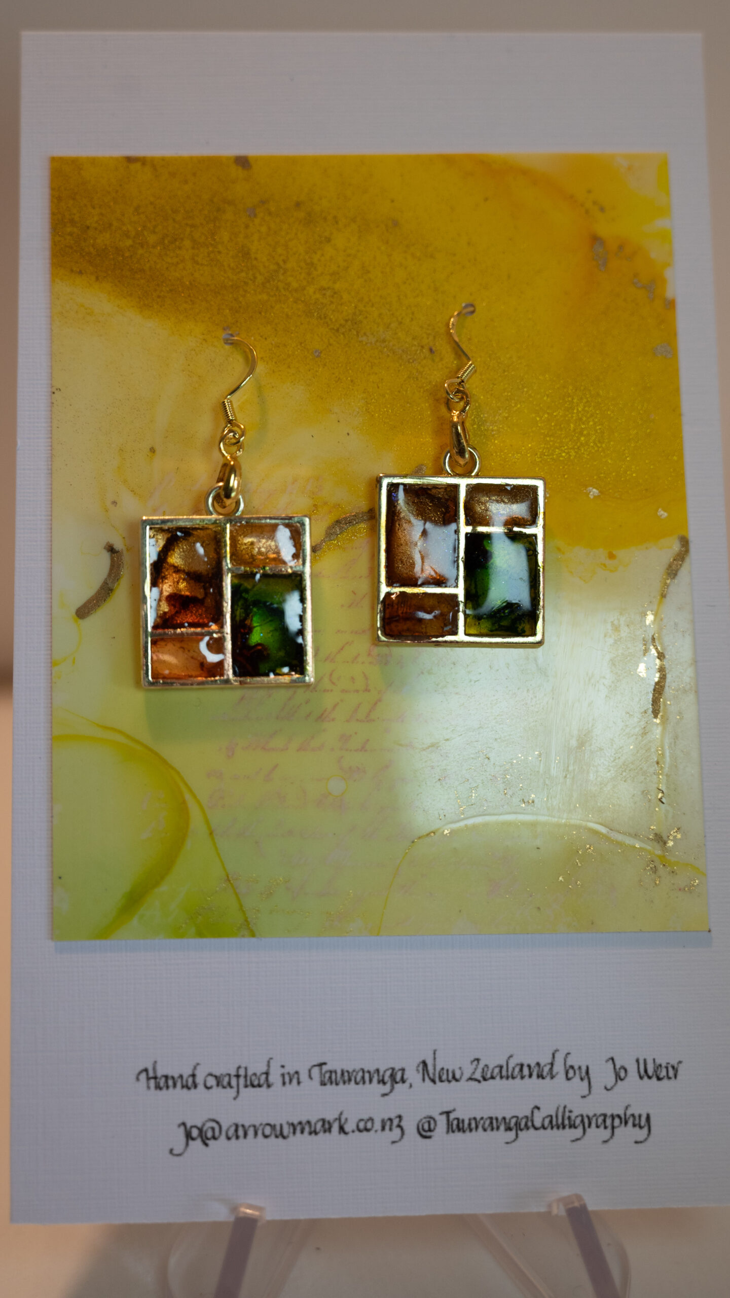 Tauranga Jewellery: Hand made earrings crafted from green and gold ink and resin set in gold metal window bezels.