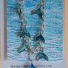 Jewellery: Whale Tail Necklace. Silver-coloured ink and resin whale tails hand crafted and hung from a silver coloured chain link necklace.