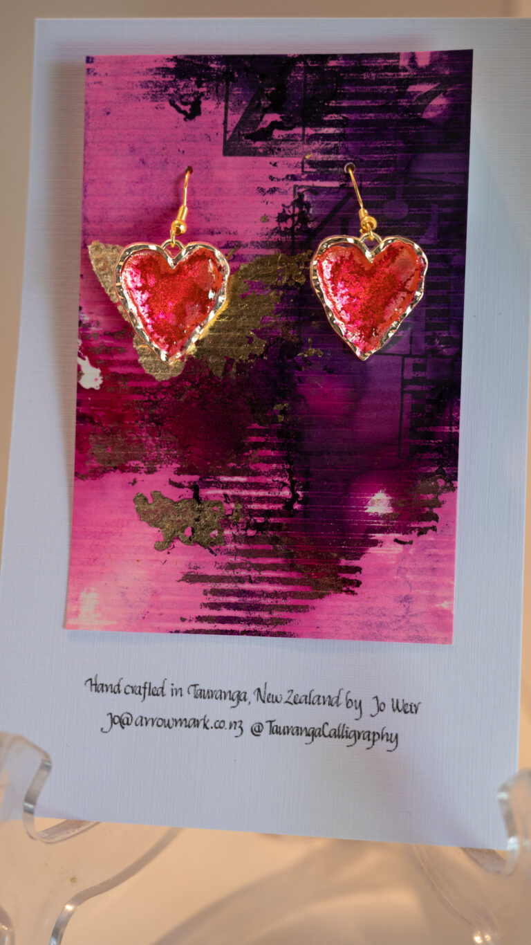 Tauranga Jewellery: Hand made earrings featuring red and gold inks and resin set in gold coloured heart shaped bezels