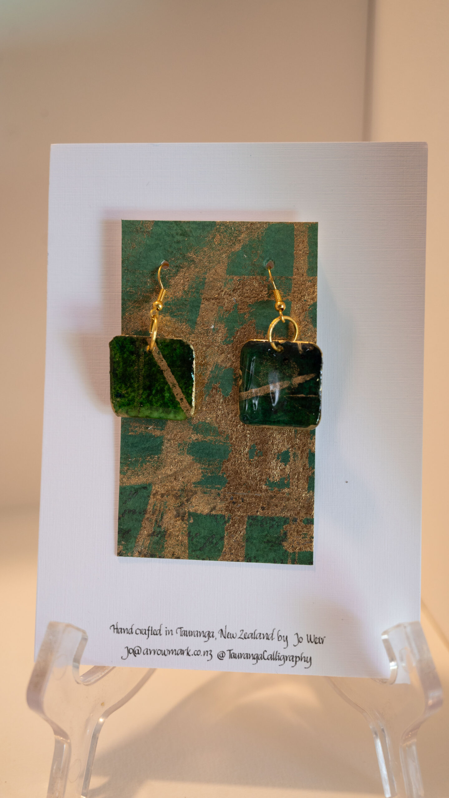 Tauranga Jewellery: hand made green and gold square shaped earrings. Crafted from card stock, ink and resin.