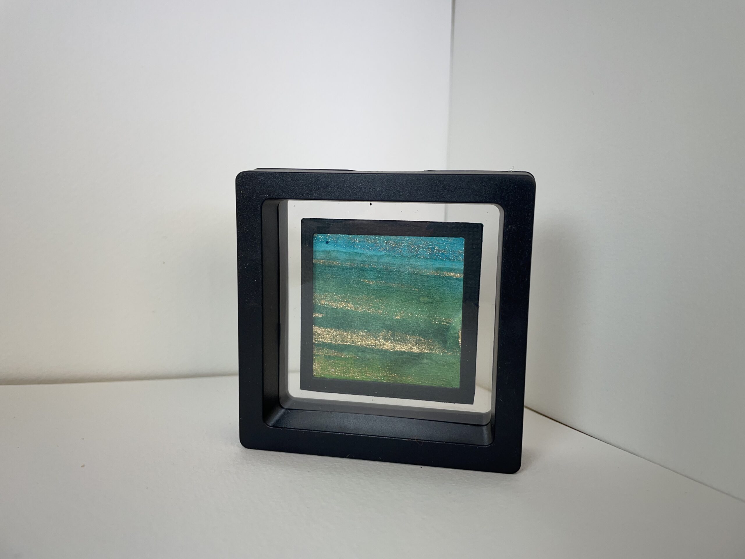 Miniature art, double sided featuring green, blue, teal and gold inks. 7cm Square - perfect for a window sill or glass cabinet so both sides can be displayed. . NZ MADE