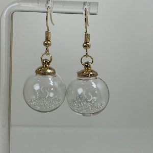 Perfect for the festive season, these sparkly, dangly earrings are mini tree ornaments filled with tiny crystals.  Very special and unusual. 