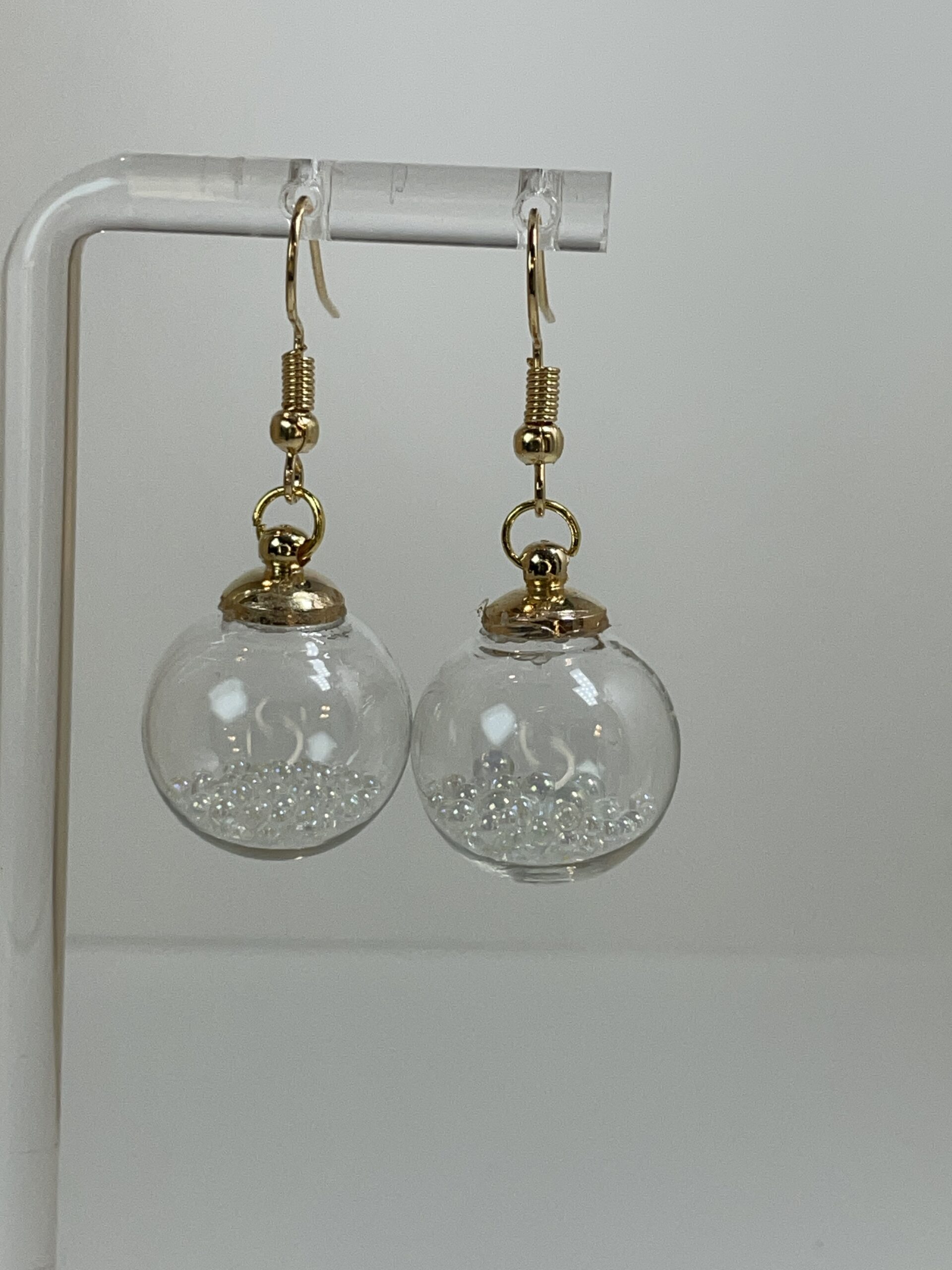 Perfect for the festive season, these sparkly, dangly earrings are mini tree ornaments filled with tiny crystals.  Very special and unusual. 