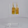 Hand crafted earrings ing golds, greens and yellows. Ink, resin and metal.