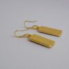 Hand crafted earrings ing golds, greens and yellows. Ink, resin and metal.