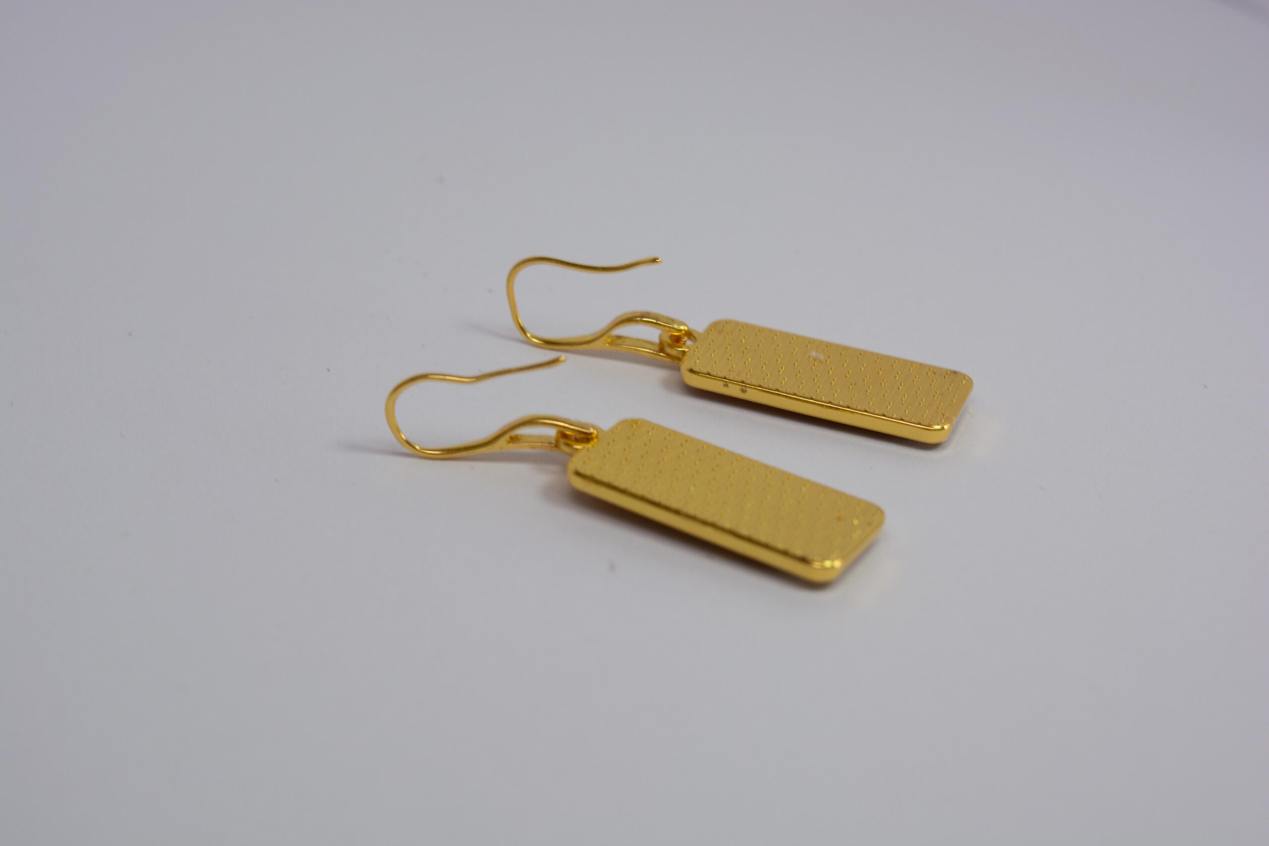 Hand crafted earrings ing golds, greens and yellows. Ink, resin and metal.