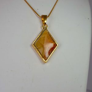 Diamond shaped double sided pendant in greens, yellows and oranges.