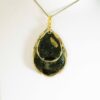 Hand crafted tear drop shaped pendant made from gold and black inks, set in a gold bezel and finished with shiny resin. Double sided.