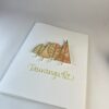 Hand made greeting card featuring four die cut gold trees filled with alcohol ink art and calligraphy text "Tauranga, NZ".