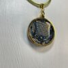 Hand made in Tauranga, this pendant is crafted from paper, ink, resin and metal. It's perfect to pair with blue outfits.
