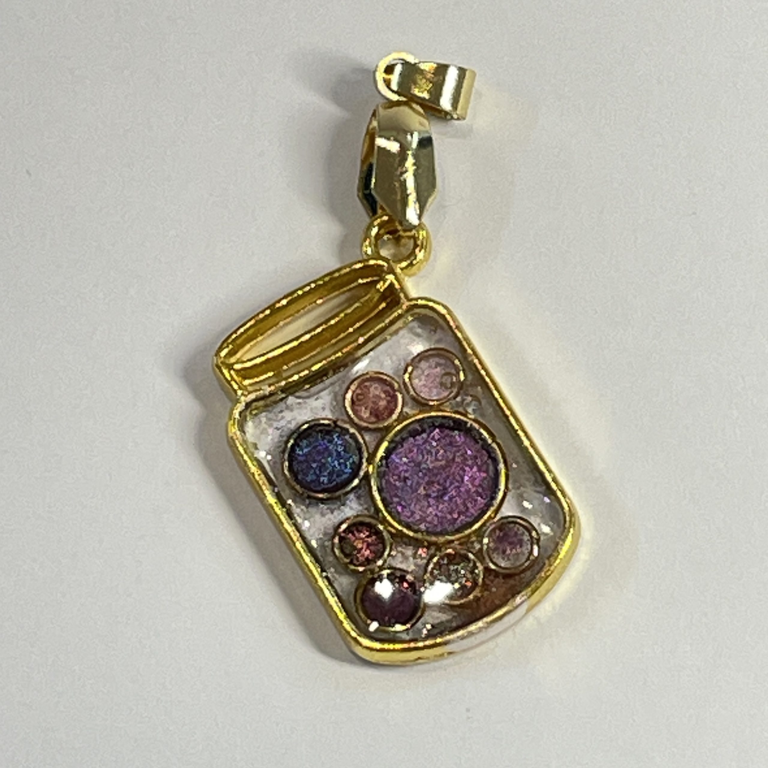 Hand made jar pendant featuring hand crafted sparkly bubbles encased in gold coloured metal Hand made jar pendant featuring hand crafted sparkly bubbles encased in gold coloured metal