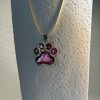 Hand made pendant featuring chameleon colour shift pigment in a silver-coloured pet paw bezel