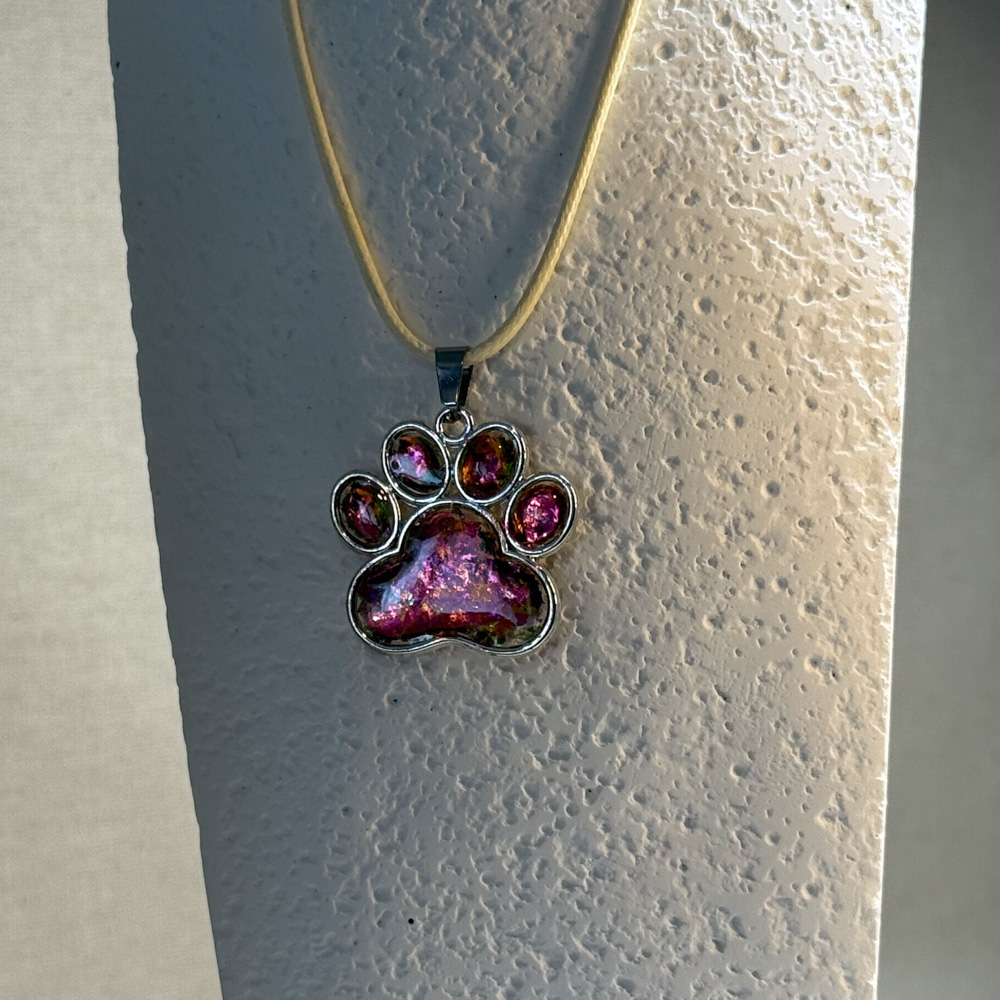 Hand made pendant featuring chameleon colour shift pigment in a silver-coloured pet paw bezel Hand made pendant featuring chameleon colour shift pigment in a silver-coloured pet paw bezel