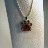 Hand made pendant featuring chameleon colour shift pigment in a silver-coloured pet paw bezel