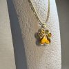 Hand made pendant featuring chameleon colour shift pigment in a silver-coloured pet paw bezel