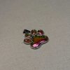 Hand made pendant featuring chameleon colour shift pigment in a silver-coloured pet paw bezel